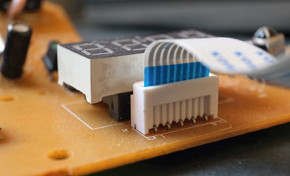 9-pin flexible data cable plugged the socket that used in industrial electronic works. Focused on the flat cable.