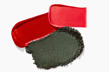Colorful cosmetics texture composition with lipstick, eyeshadow, bronzer, glitter, and powder on a...