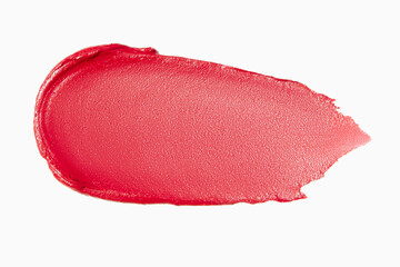 Matte red lipstick smear on a light white background. Cosmetic texture.
