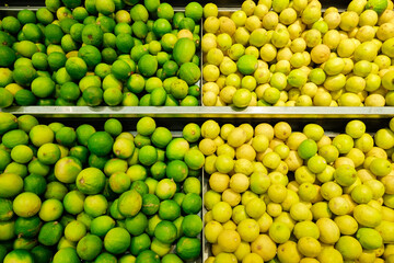 lemons and limes on counter in supermarket