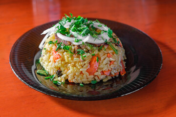 pilaf on dark plate, selective focus