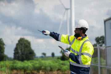 Service engineers checking system of windmill. Wind turbines generate electricity. Clean and...