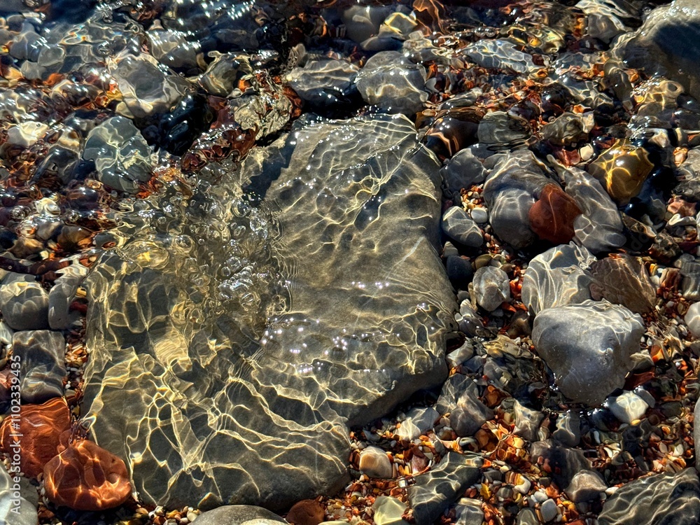 Poster Stones and pebbles in ocean transparent water 