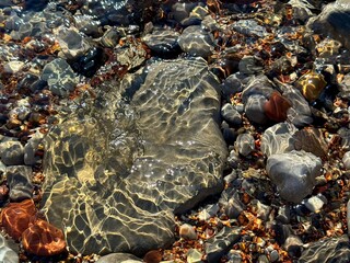 Stones and pebbles in ocean transparent water 