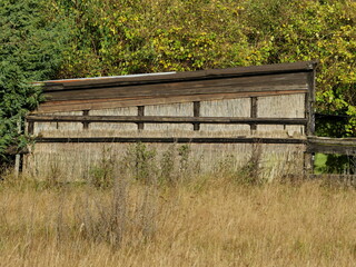 Pasture and weather hut made of wood and thatch. A harmonious interplay of natural materials and...