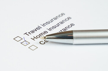 Checking off insurance options on a printed checklist with a pen