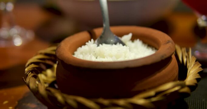 Hot white cooked rice steam bowl kitchen background mixed wooden spoon. Sticky rice after cooked. Asia China Thailand Japan India. Sushi roll delicious traditional food vegan friendly