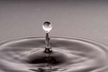 High-Speed Water Drop Collision: Artistic Liquid Splash with Reflective Details and Dark Background