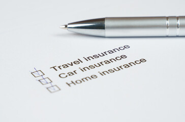 Essential insurance checklist with a silver pen for planning protection