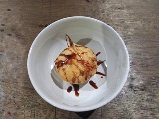 Pancakes with melted sweet chocolate on top in a white bowl
