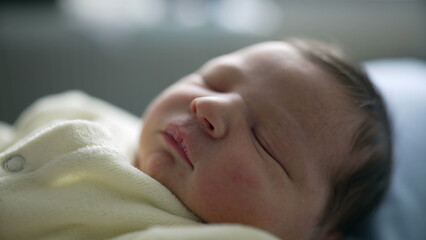 Newborn baby sleeping peacefully in a cozy white outfit, showing a serene and relaxed expression....