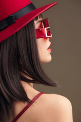 Red hat, sunglasses, woman with ponytail looking into the distance, wearing a red hat and stylish...