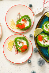 Spinach roll with cream cheese, salmon and red caviar