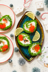 Spinach roll with cream cheese, salmon and red caviar