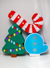 Christmas piñatas with candies: Christmas tree, red Christmas candy and blue mitten with snowflakes