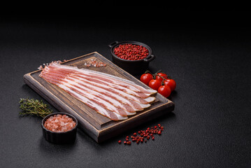 Fresh raw bacon sliced with spices and herbs
