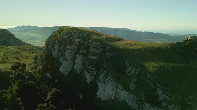 Flying over the mountains covered with beautiful green pine forests.