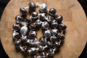 Overhead view of nigerian baba dudu candy on wood background, top view of Ghana coconut candy or kube toffee candy, hard candy made with coconut milk and sugar on wood board