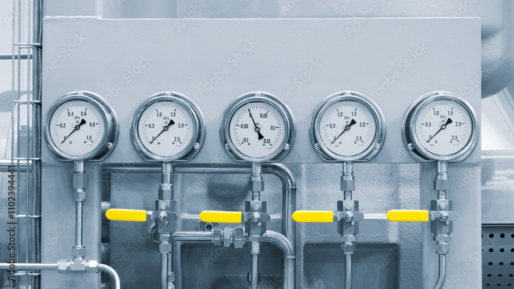 Poster four pressure gauges are attached to a pipe. the gauges are yellow and have the numbers 1 through 4 