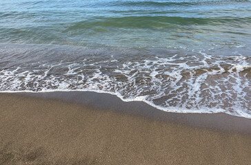 the sea wave rolls over the colorful pebbles on the Black Sea coast