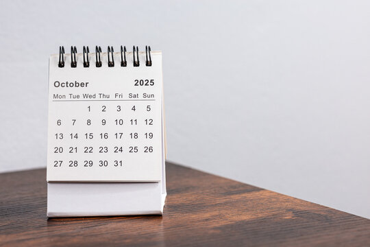 Minimalistic photo of a desk calendar showing October 2025. Clean and professional design, perfect for themes related to time management, planning, or organization.