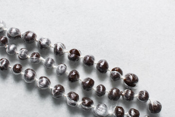 Overhead view of nigerian baba dudu candy on white background, top view of Ghana coconut candy or kube toffee candy, hard candy made with coconut milk and sugar on granite countertop