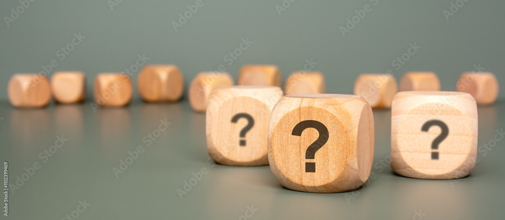Poster wooden dice featuring question marks displayed on a vibrant green background for effect