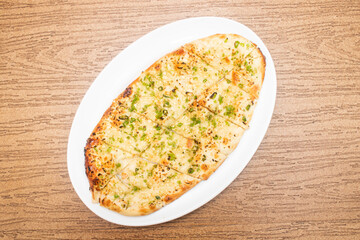 Garlic with chili nan served in tray dish isolated on wooden table top view of bangladeshi food