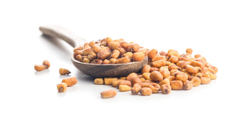 Roasted salted corn snack on wooden spoon isolated on white background.