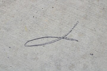 religious fish drawn on the sidewalk