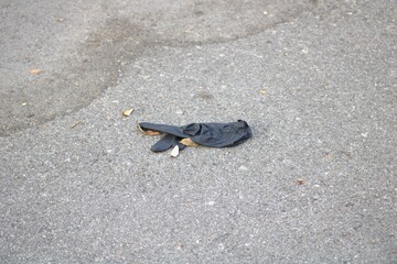 black nylon glove on the pavement