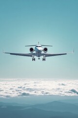 Fototapeta premium A sleek white jet aircraft flying above fluffy clouds, showcasing modern aviation technology against a bright blue sky.