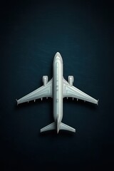 Top view of a sleek, modern aircraft against a dark textured background, emphasizing sleek design and engineering.