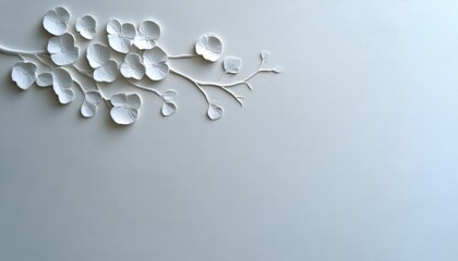 Delicate white paper flowers are elegantly crafted against a soft gray backdrop