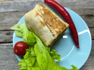 shawarma on a plate on a white plate . photos in high quality