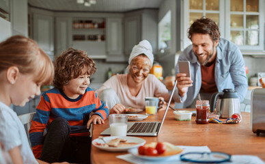 Happy family enjoying breakfast together in kitchen