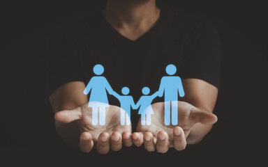 Adult hands hold a family children icon, family home, adoption foster care, homeless support,...