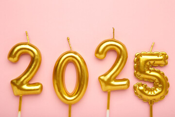 Holiday background Happy New Year 2025. Numbers of year 2025 made by gold candles on pink background.