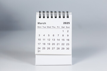 Minimalistic photo of a desk calendar displaying March 2025. Clean and professional design, suitable for topics like planning, organization, and productivity.