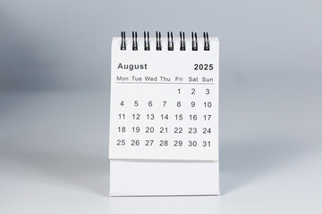 Minimalistic photo of a desk calendar displaying August 2025. Clean and professional design,...