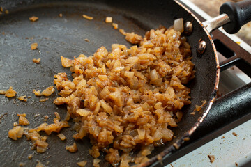 A view of the process of cooking caramelized onions.