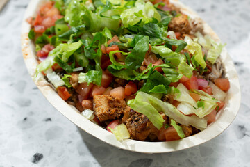 A view of a restaurant style chicken burrito bowl.