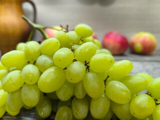 Green ripe juicy grapes on the table.