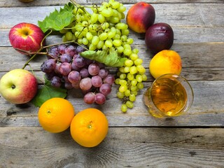 grapes are green red blue on the table surrounded by fruits