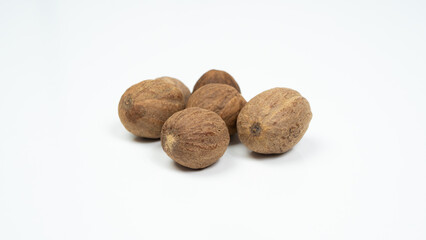 Whole nutmegs, isolated on a white background. Close up.