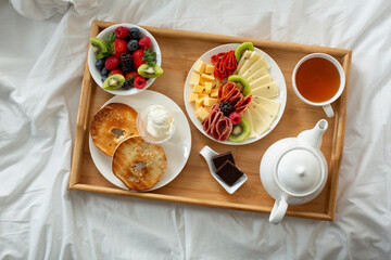 A top down view of a catered breakfast in bed tray.