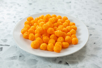 A view of some cheese balls on a plate.