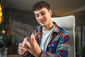 man check if the eyeglasses are clean and prepare for study at home