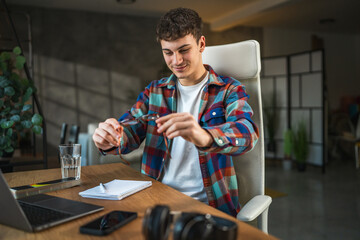 Fototapeta premium man check if the eyeglasses are clean and prepare for study at home