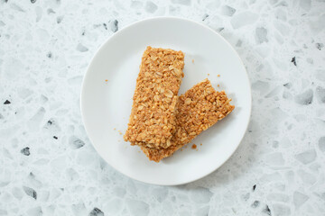 A top down view of a plate of crunchy granola bars.